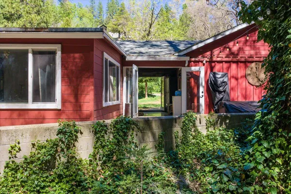 a view of a house with a small yard and floor to ceiling window