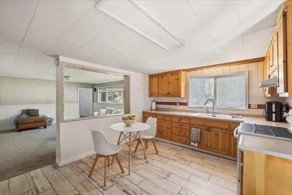 a large white kitchen with a large window
