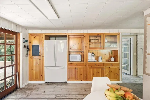 a living room with stainless steel appliances furniture and a rug