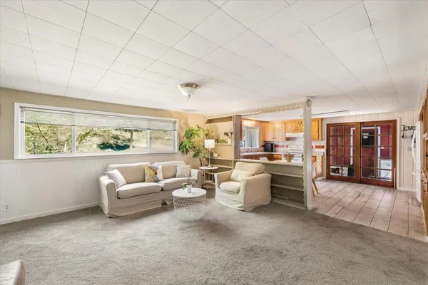 a living room with furniture and a large window