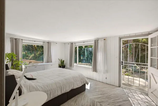 a bedroom with a large bed and a large window