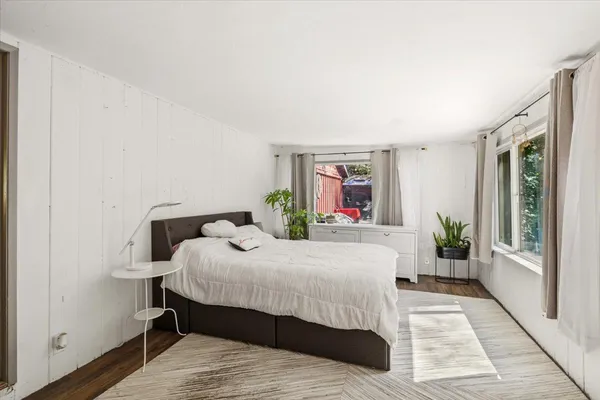 a bedroom with a large bed table and a window