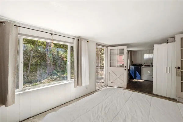 a view of a livingroom with walk in closet and bedroom
