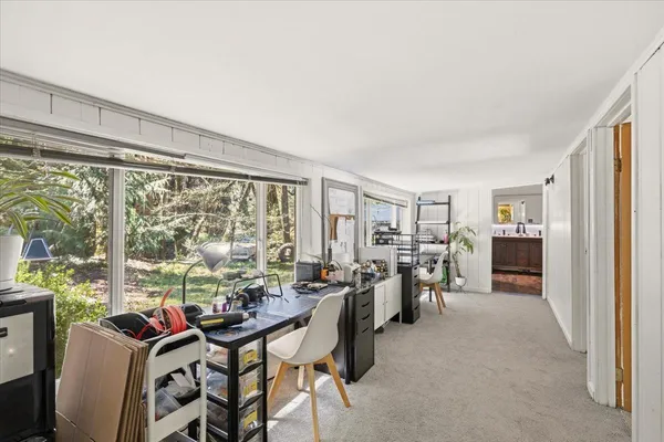 a view of a livingroom with furniture and a window
