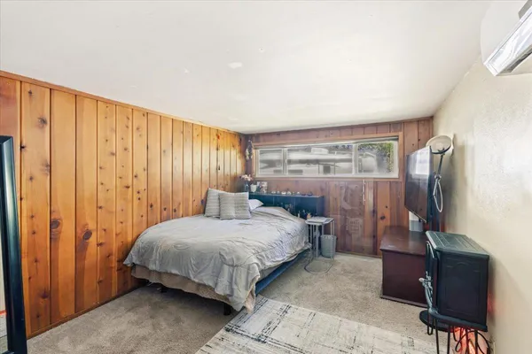 a bedroom with a bed and a mirror