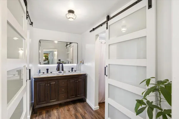 a bathroom with a double vanity sink mirror and shower