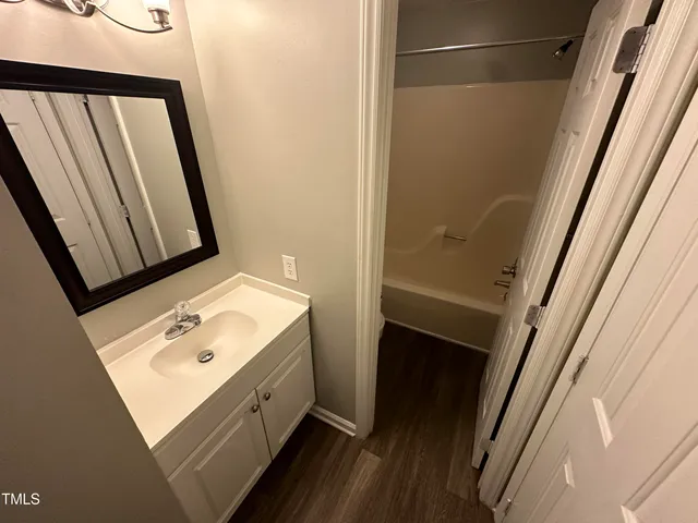a bathroom with a sink a mirror and a shower