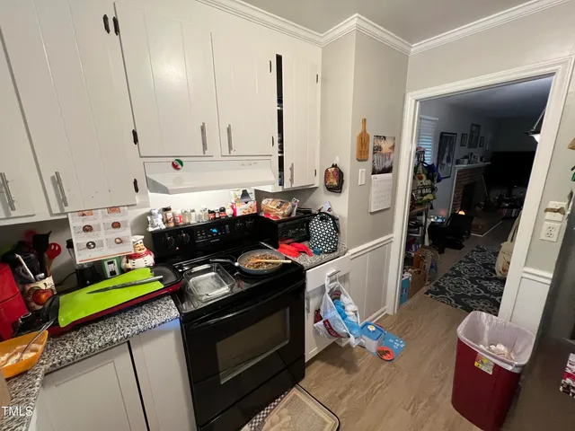 a kitchen with stainless steel appliances granite countertop a stove and a refrigerator