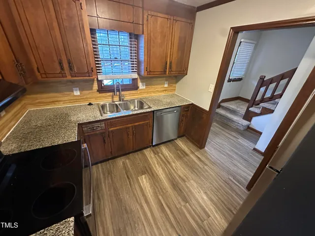 a kitchen with wooden cabinets and a sink