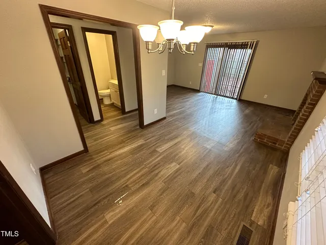 a view of a room with wooden floor and staircase