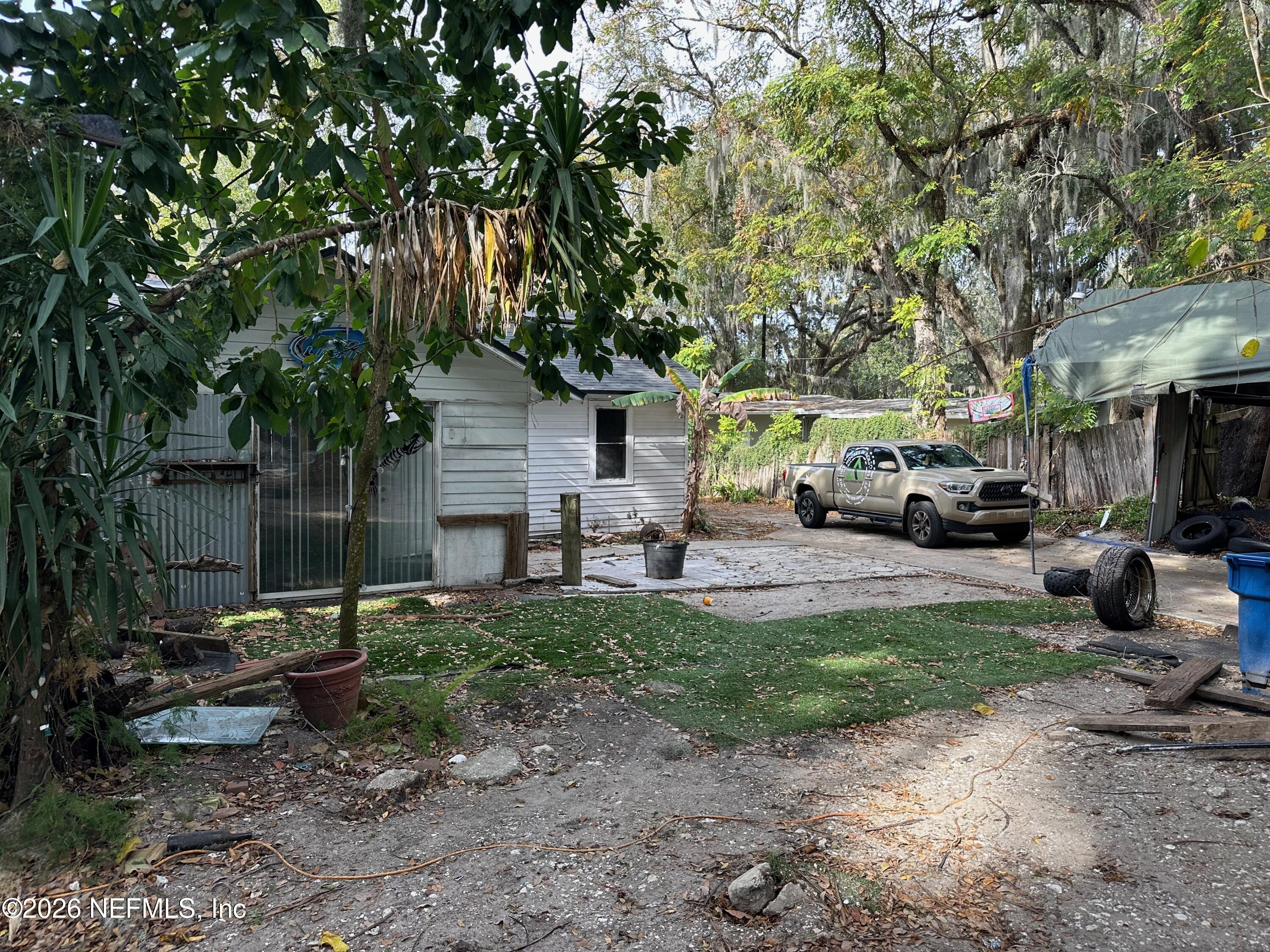 421 Arlington Road North Jacksonville, FL 32211 - Photo 12 of 25 a view of a patio with table and chairs under an umbrella