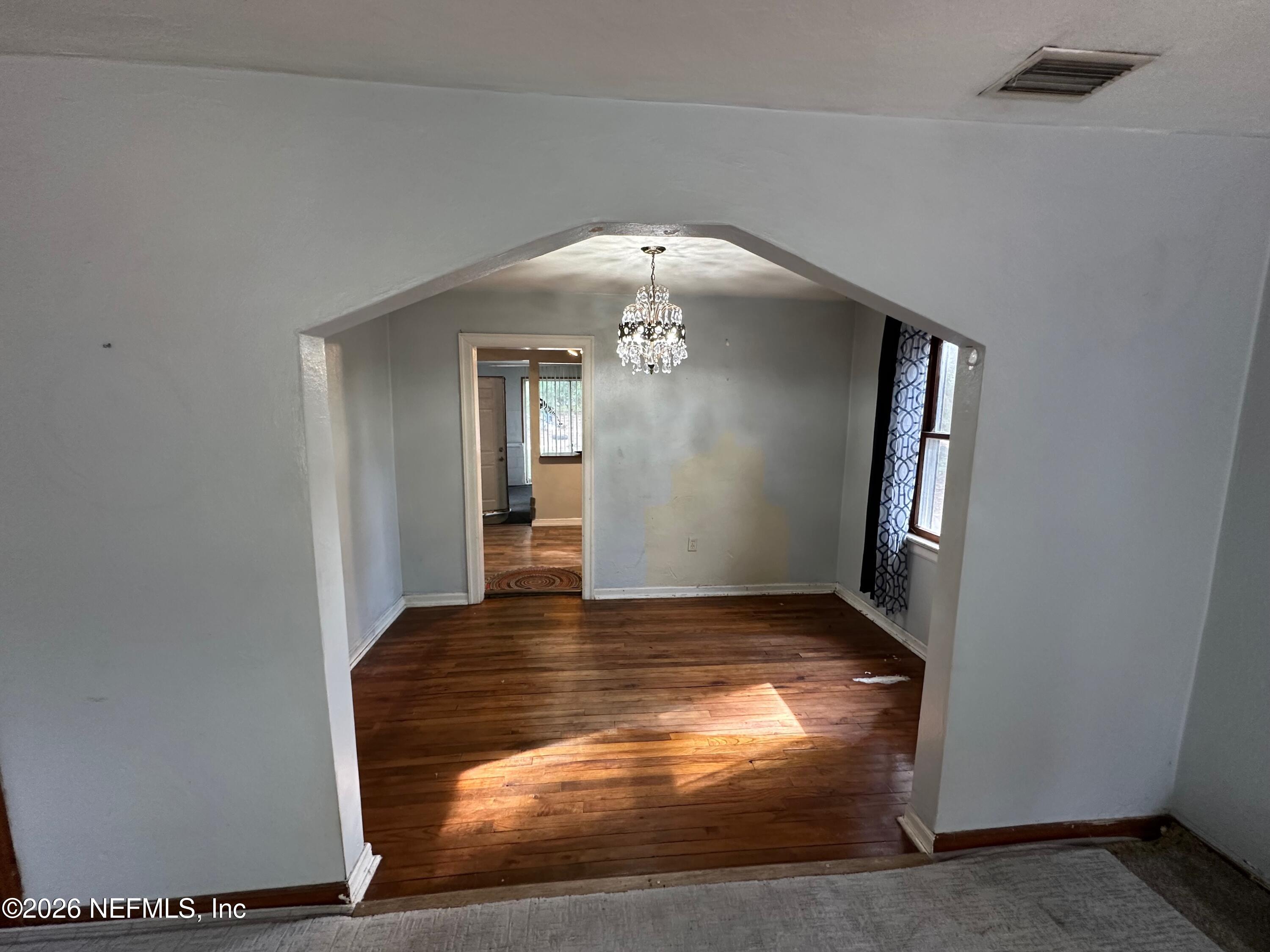 421 Arlington Road North Jacksonville, FL 32211 - Photo 18 of 25 a view of a hallway with wooden floor and a living room
