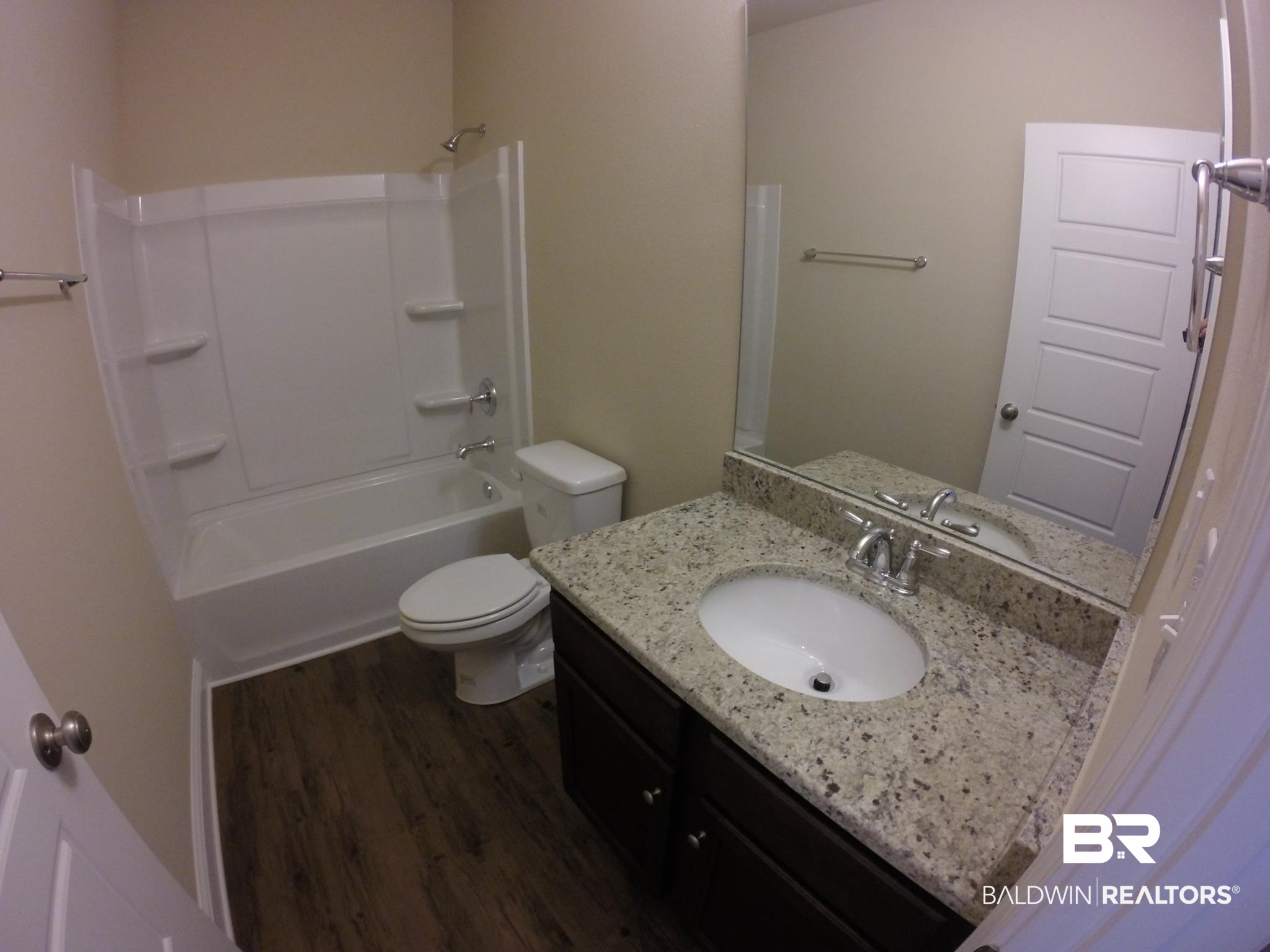 2996 Notsram Court Mobile, AL 36695 - Photo 12 of 16 Bathroom featuring wood finished floors, toilet, washtub / shower combination, and vanity