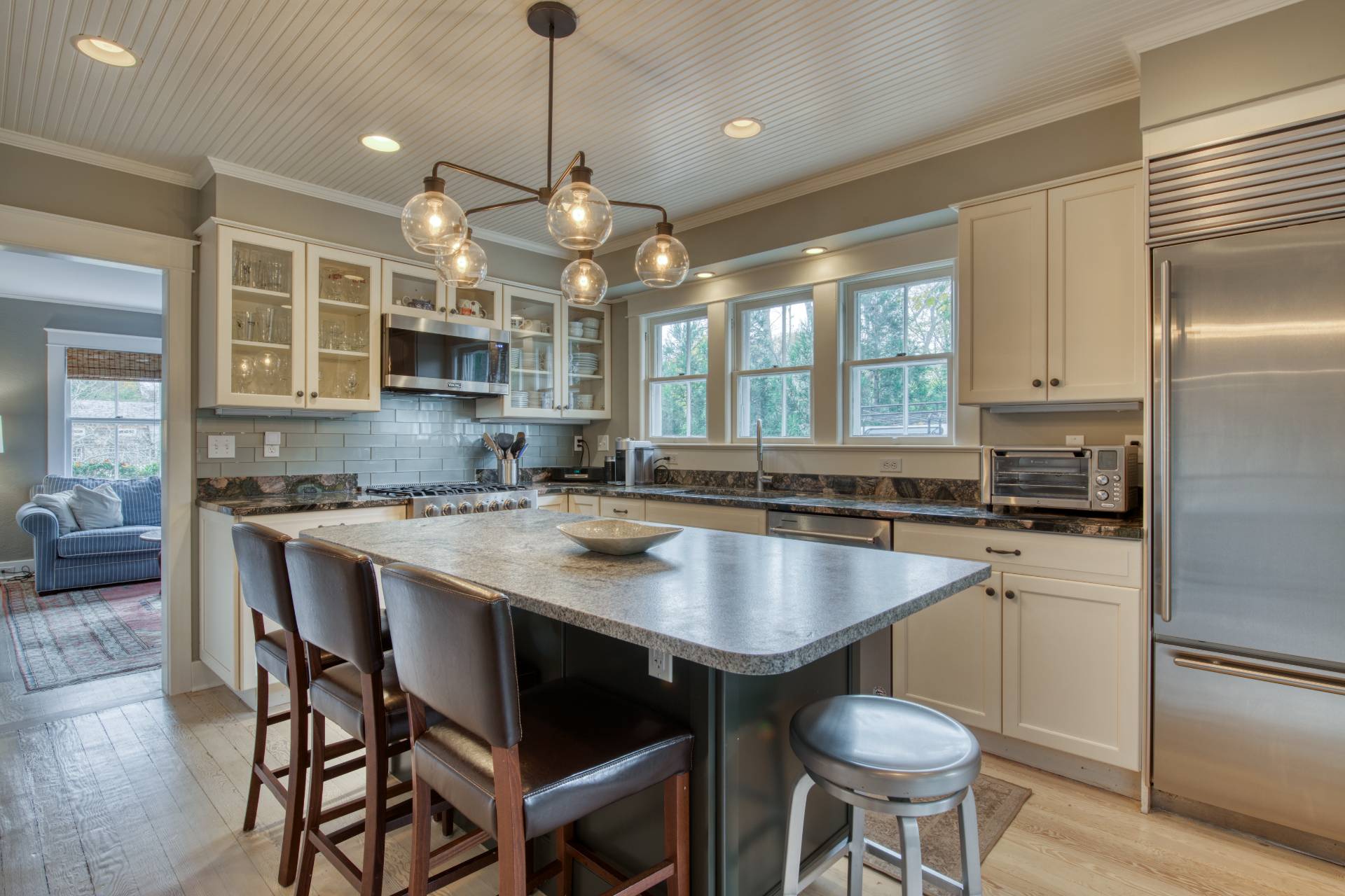 151 Church Lane Bridgehampton, NY 11932 - Photo 3 of 20 a kitchen with a center island and stools in it