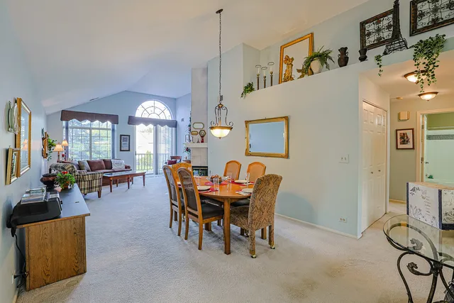 a view of a dining room with furniture and chandelier