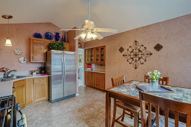 a kitchen with stainless steel appliances granite countertop a refrigerator a stove a sink and dishwasher