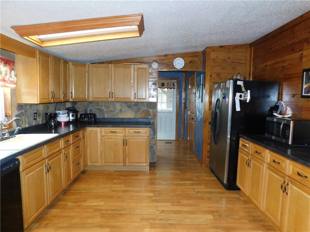 1199 Banning Road Dawson, PA 15428 - Photo 13 of 24 a kitchen with stainless steel appliances granite countertop a refrigerator sink and cabinets
