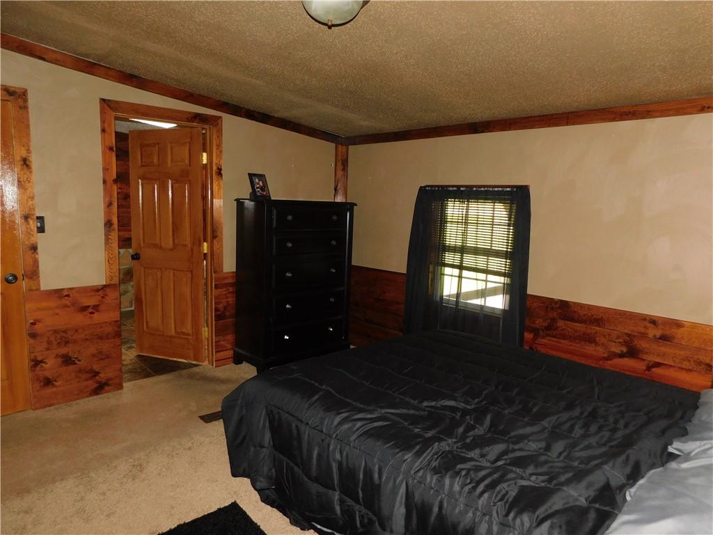 1199 Banning Road Dawson, PA 15428 - Photo 15 of 24 a bedroom with a bed and wooden floor