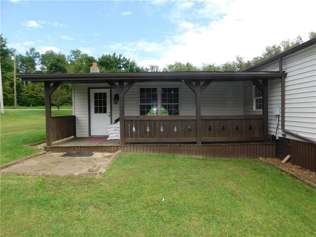 1199 Banning Road Dawson, PA 15428 - Photo 24 of 24 a front view of house with yard and trees in the background
