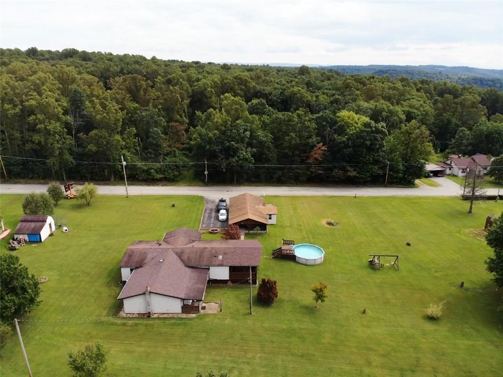 1199 Banning Road Dawson, PA 15428 - Photo 4 of 24 a backyard of a house with table and chairs