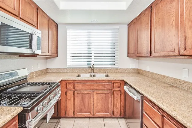 a kitchen with stainless steel appliances granite countertop a sink stove and cabinets