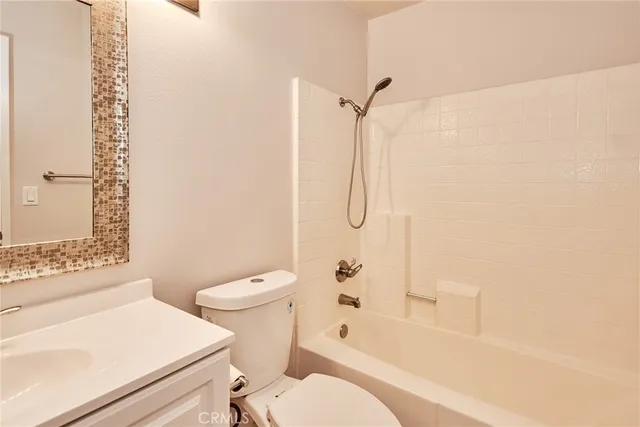 a bathroom with a sink a toilet and mirror