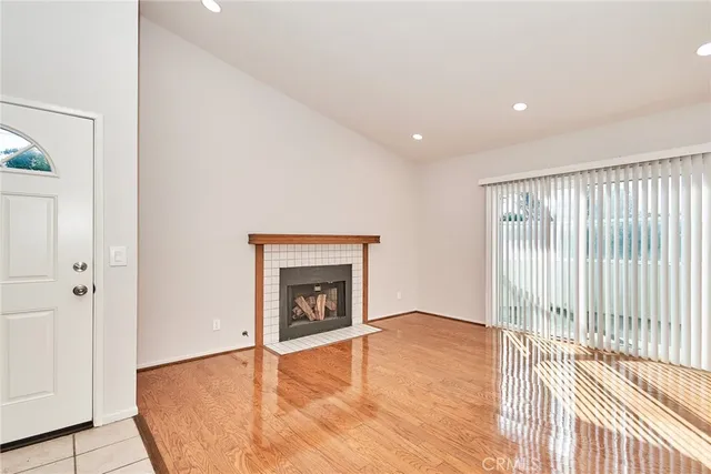 a view of an empty room with closet and a window