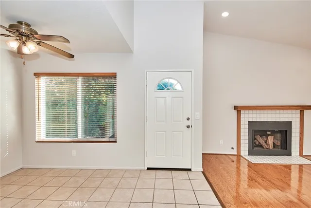 a view of a livingroom with a fireplace and window