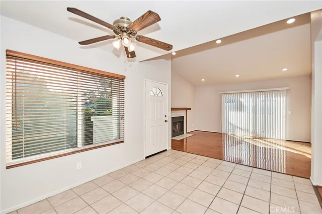 a view of a livingroom with a ceiling fan and window
