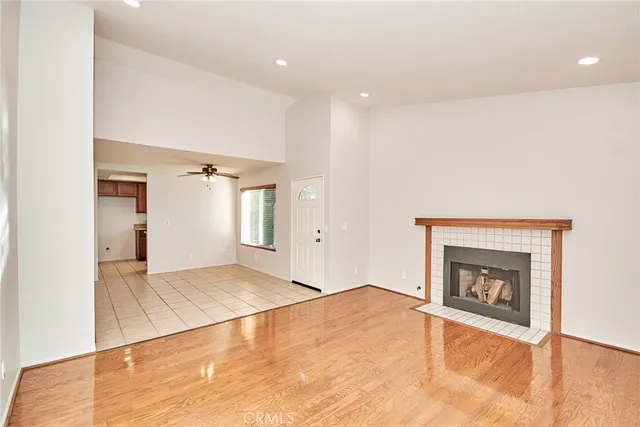 a view of an empty room with a fireplace and a window