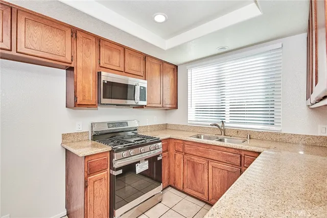 a kitchen with stainless steel appliances granite countertop a sink stove and microwave