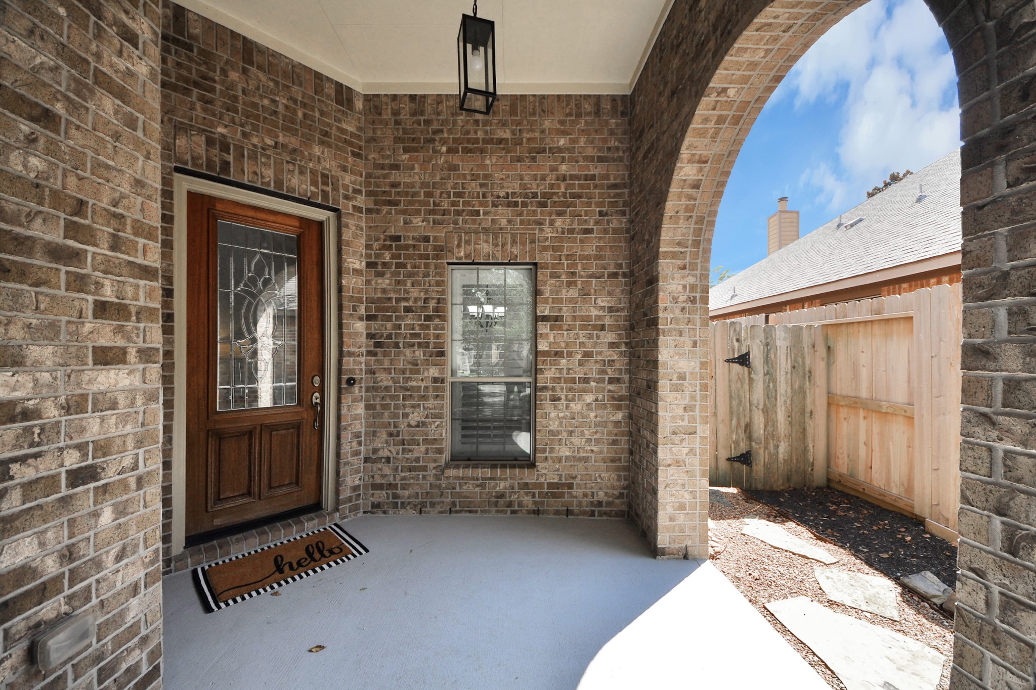 27515 Chris Ridge Court Spring, TX 77386 - Photo 9 of 48 Enjoy mornings on this spacious covered front porch with beautiful archway.