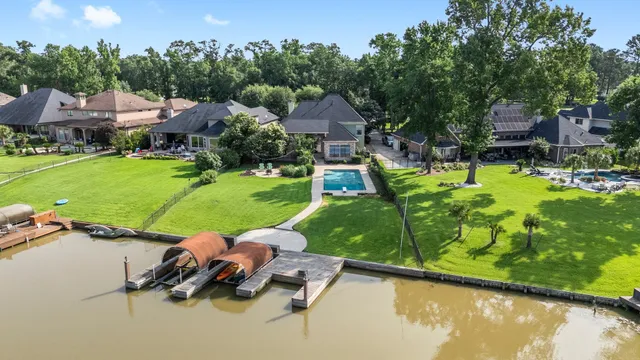 a view of a lake with a garden and houses