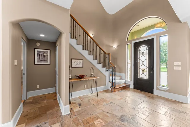 a view of entryway and hall with a front door