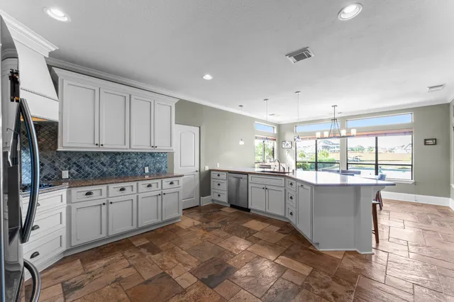 a large kitchen with a large window