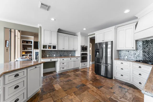 a kitchen with granite countertop cabinets and stainless steel appliances