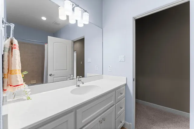 a bathroom with a sink vanity and a mirror