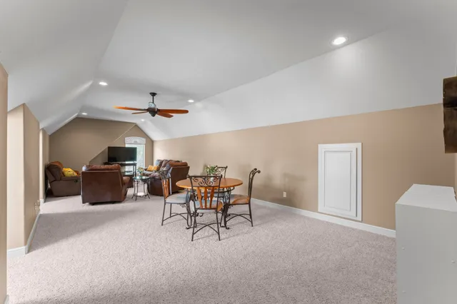 a living room with furniture a flat screen tv and a window