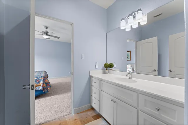 a en suite bathroom with a double vanity sink and a mirror