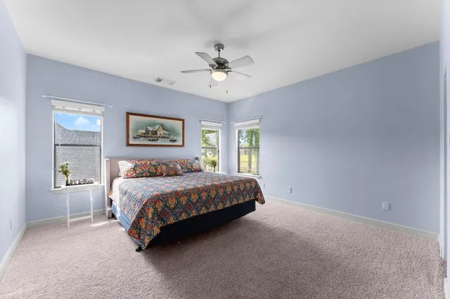 a bed sitting in a bedroom next to a window