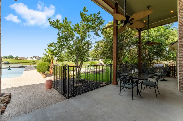 a view of a porch with furniture and a yard