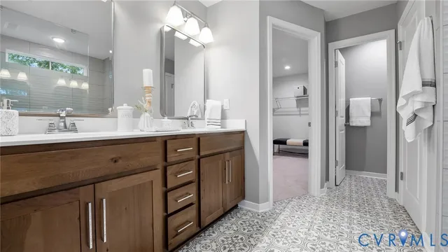 a bathroom with a double vanity sink a mirror and a shower