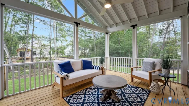 a living room with furniture and a floor to ceiling window