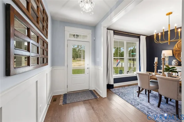a view of a livingroom with furniture window and wooden floor