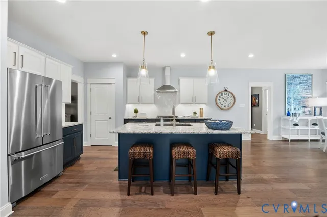 a kitchen with granite countertop a refrigerator a stove a oven and a refrigerator