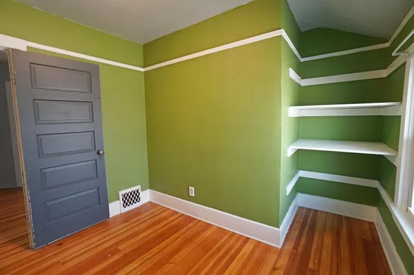 a view of a room with wooden floor and small closet