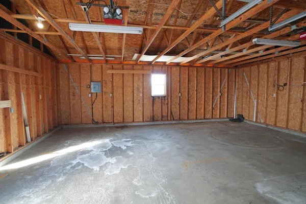 a view of a livingroom with wooden floor and a fireplace