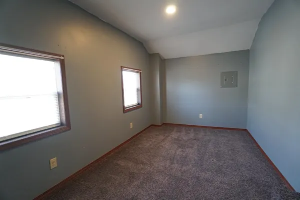 a view of a livingroom with a chandelier fan and a window
