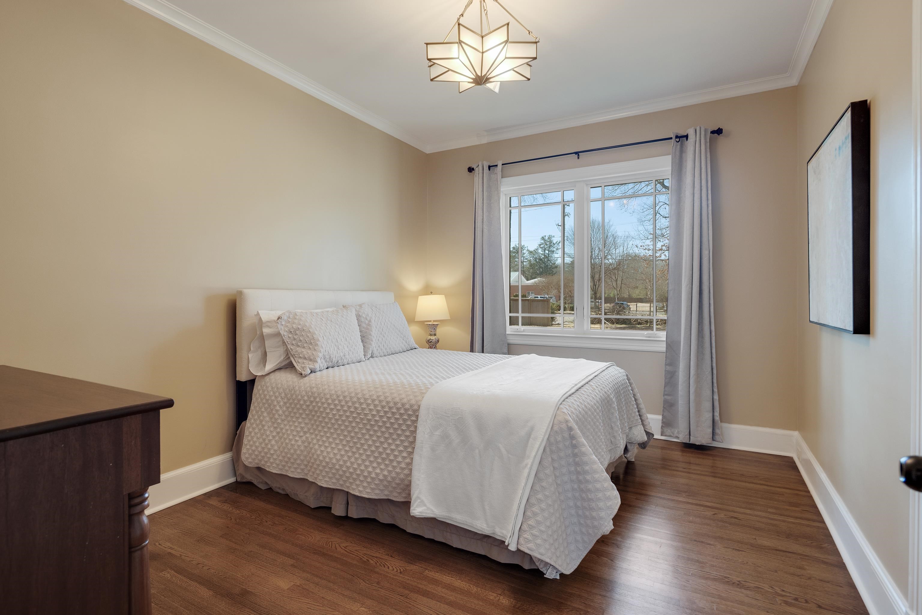 90 North Perkins Road Memphis, TN 38117 - Photo 16 of 25 a bedroom with a large bed and a window