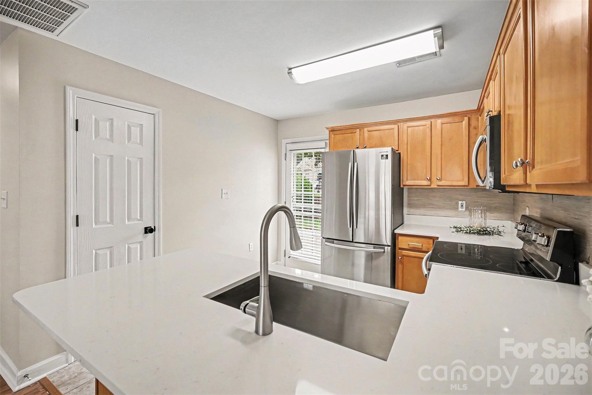1210 Sheldon Brook Lane Fort Mill, SC 29707 - Photo 7 of 26 a kitchen with stainless steel appliances granite countertop a refrigerator a stove and a sink with granite countertops
